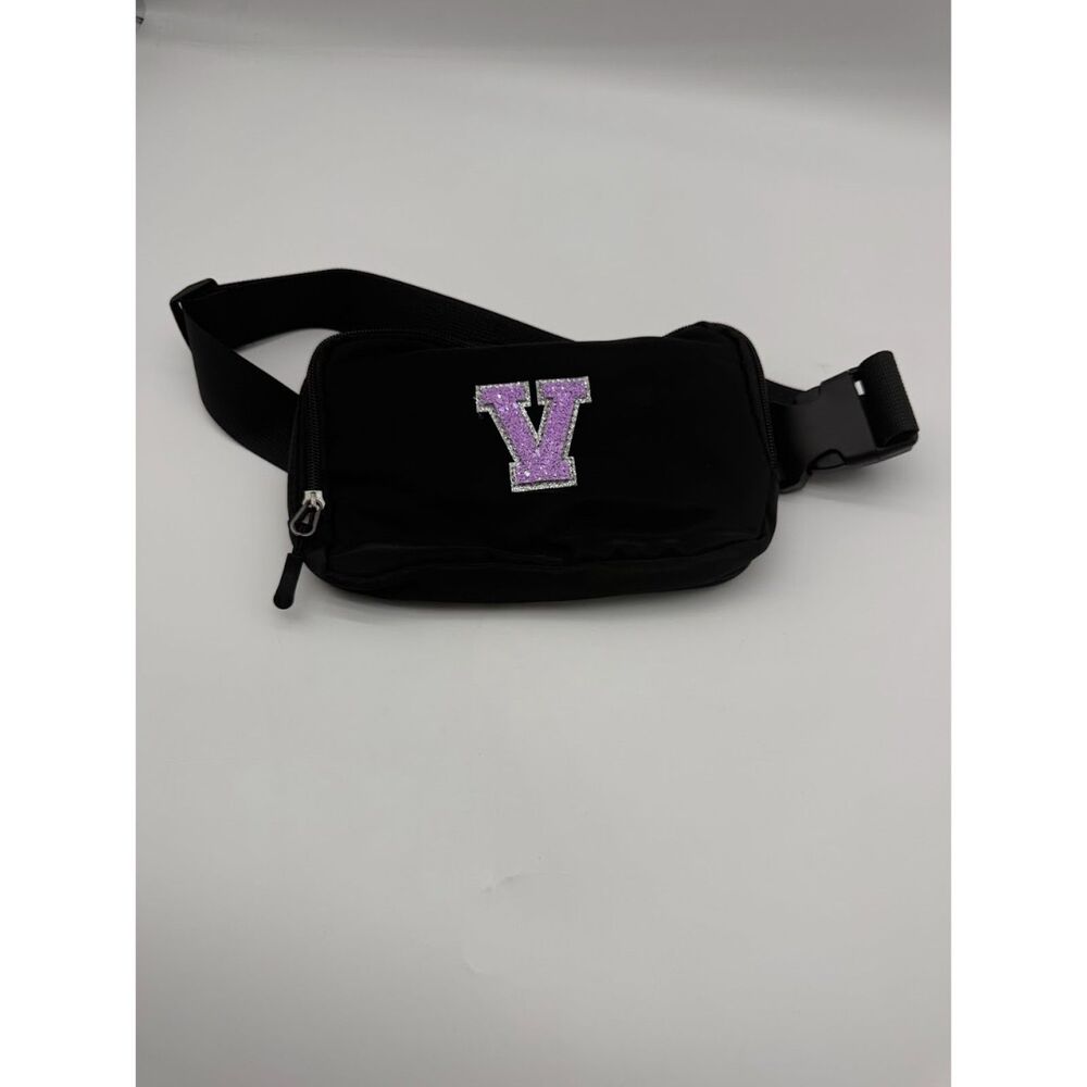 Fanny pack Black belt bag with a purple initial 'V' patch.